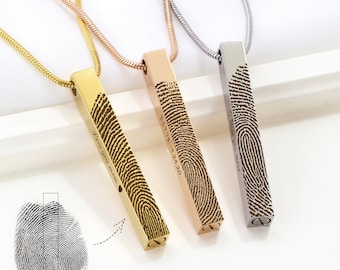 May include: Three pendant necklaces in gold, rose gold, and silver, each featuring a rectangular bar with a fingerprint design. The gold pendant has the text "Love you mom". The rose gold pendant has the text "5.31.78 - 9.24.20". The silver pendant has the text "Miss you more".