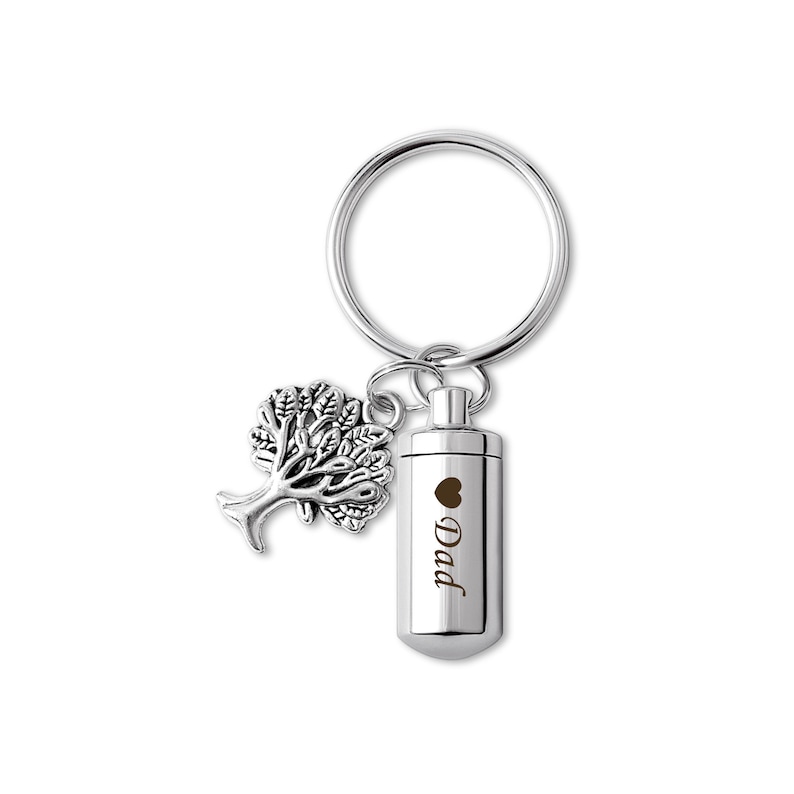 May include: Silver keychain with a small tree charm and a cylindrical cremation urn engraved with "Dad" and a heart.