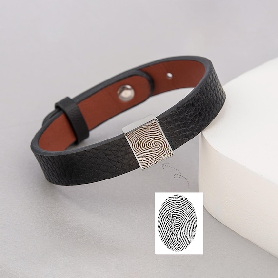 Your actual fingerprint etched into a genuine leather bracelet — a tactile, wearable memorial that carries a real person's unique mark.