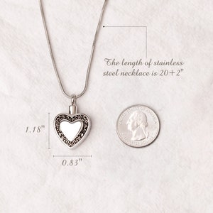 May include: A silver heart-shaped cremation necklace with a clear glass insert. The necklace is 20 inches long and the heart pendant is 1.18 inches wide and 0.83 inches tall.
