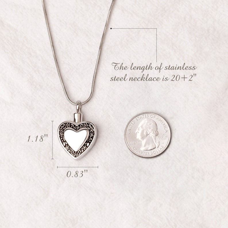 May include: A silver heart-shaped cremation necklace with a clear glass insert. The necklace is 20 inches long and the heart pendant is 1.18 inches wide and 0.83 inches tall.