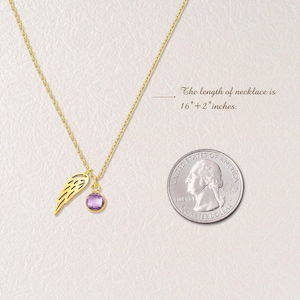 May include: A gold-colored necklace with a pendant featuring a purple gemstone and a wing charm. The necklace is 16" + 2" inches long. A U.S. quarter is next to the necklace for size comparison.