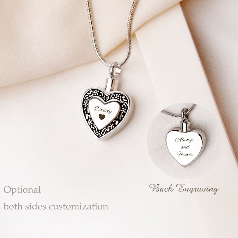 May include: Silver heart-shaped cremation necklace with a chain. The front of the pendant is engraved with the word "Daddy" and a small heart. The back of the pendant is engraved with the words "Always and Forever".