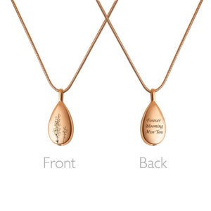 May include: A rose gold necklace with a teardrop-shaped pendant. The front of the pendant features an engraved floral design. The back of the pendant is engraved with the words "Forever Blooming Miss You".