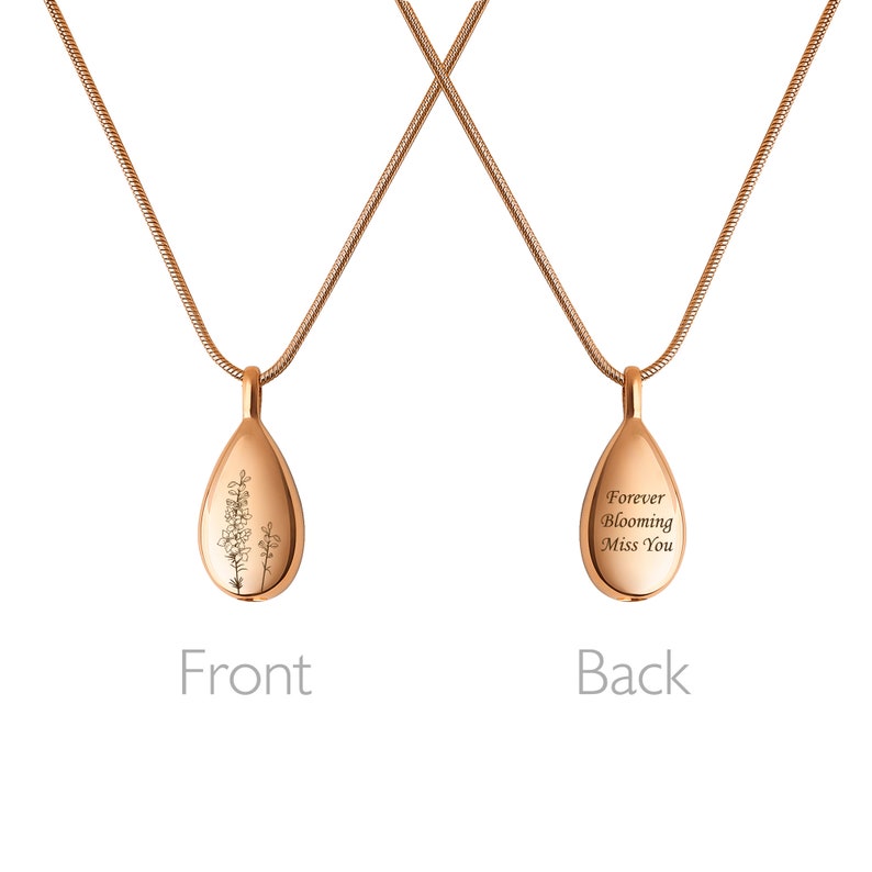 May include: A rose gold necklace with a teardrop-shaped pendant. The front of the pendant features an engraved floral design. The back of the pendant is engraved with the words "Forever Blooming Miss You".