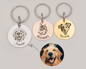 May include: Three silver, gold, and rose gold dog tag keychains with engraved dog portraits and names. The keychains feature a golden retriever, a husky, and a terrier. The names on the tags are Irwin, Thomas, and Rocky.