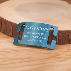 May include: Blue metal dog tag with engraved text: "Dannie, 100 Canada Ct., City of Industry, CA, 123-456-7890".