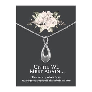 May include: Silver infinity pendant necklace with a floral design. The pendant has a small opening for ashes or other keepsakes. The necklace comes with a card that reads "Until We Meet Again... There are no goodbyes for us. Wherever you are, you will always be in my heart."