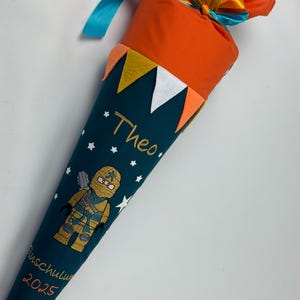 Cono scolastico Ninjago in tessuto incl. cartoncino bianco 70/85 cm ST7000