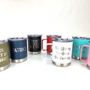 May include: Set of seven stainless steel travel mugs with various colors and personalized text. The text includes "This might be whiskey", "Patrick", "Don't touch my cup", "Be strong, be brave, be fearless", "Monica Bridesmaid", and "You can sit with us".