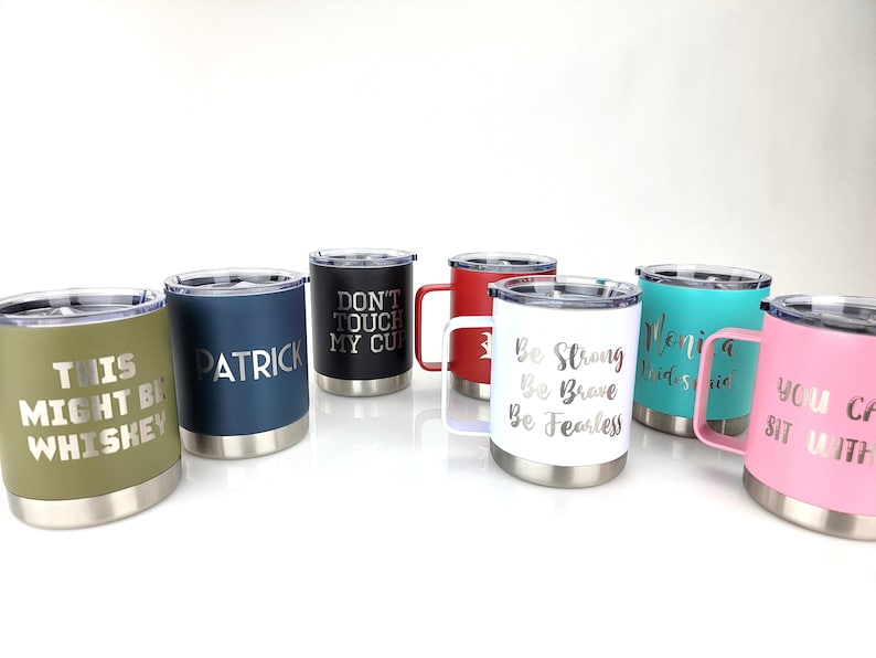 May include: Set of seven stainless steel travel mugs with various colors and personalized text. The text includes "This might be whiskey", "Patrick", "Don't touch my cup", "Be strong, be brave, be fearless", "Monica Bridesmaid", and "You can sit with us".