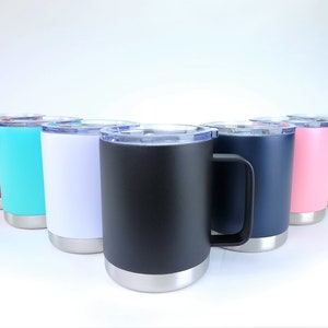May include: A collection of insulated travel mugs in various colors, including red, teal, white, black, navy, pink, and olive green. Each mug has a silver base and a clear lid. The mugs are designed to keep beverages hot or cold.