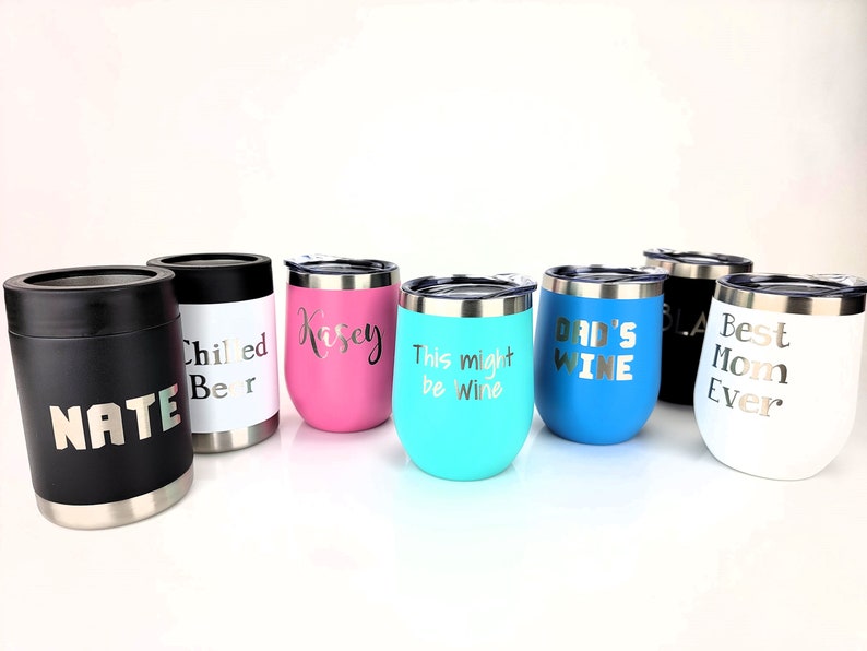 May include: Set of eight stainless steel tumblers with various colors and personalized text. The tumblers feature names, phrases like "This might be wine" and "Dad's Wine", and "Best Mom Ever".
