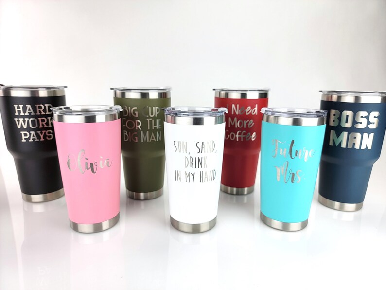 May include: Seven stainless steel tumblers with various colors and engraved text. The text includes "Hard Work Pays", "Big Up For The Big Man", "Sun, Sand, Drink In My Hand", "Need More Coffee", "Future Mrs", "Olivia", and "Boss Man".