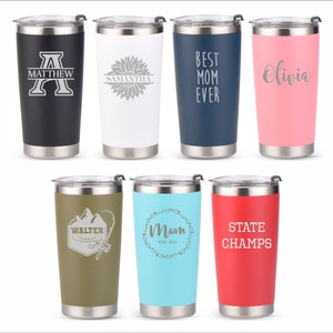 May include: Eight stainless steel tumblers with various designs and colors. The tumblers feature personalized text and graphics, including a sunflower, a mountain range, a fishing rod, and the words "Best Mom Ever".