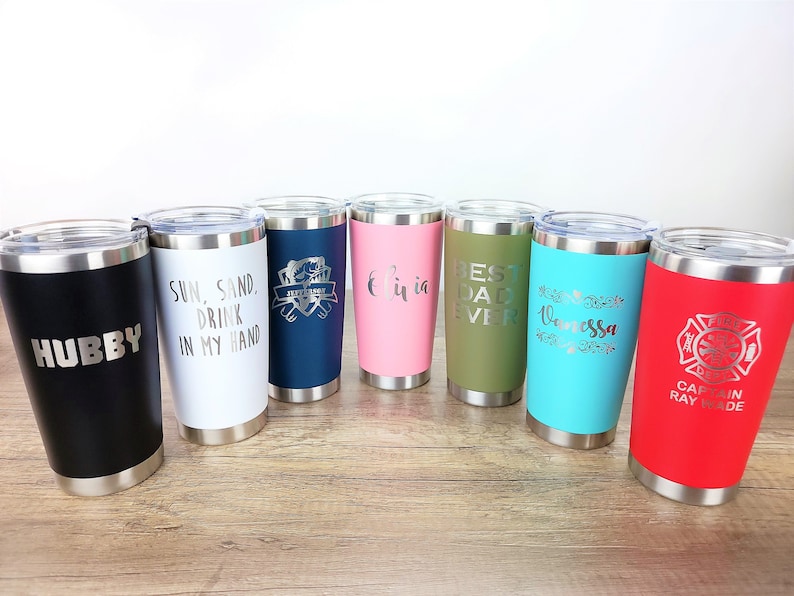 May include: Seven stainless steel tumblers with various colors and personalized text. The tumblers feature phrases like "Hubby", "Sun, Sand, Drink in my Hand", "Best Dad Ever", and "Vanessa".