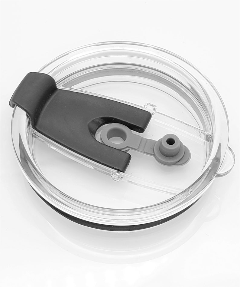 May include: A clear plastic lid with a black silicone ring and a black slider. The lid has a small gray silicone spout.