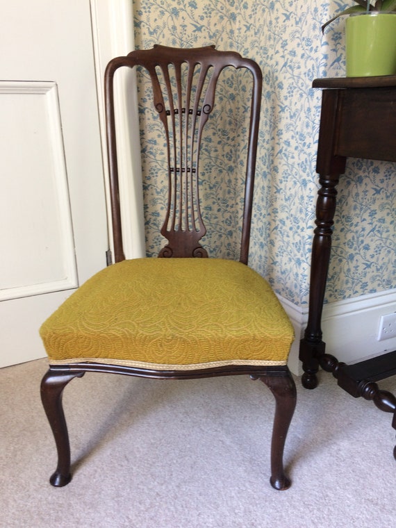 Antique mahogany nursing chair on Queen 