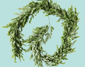 May include: A green leafy garland with a wire frame, perfect for adding a touch of greenery to your home decor.