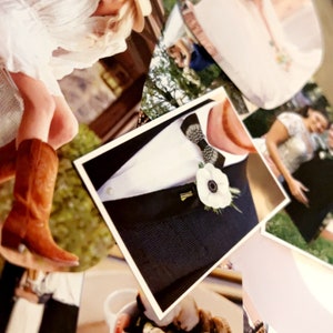 May include: A collage of photographs featuring a person in a white dress and brown cowboy boots, a wedding couple, a tuxedo with a white flower boutonniere and patterned bow tie, and a white bowl filled with cooked clams and seafood.
