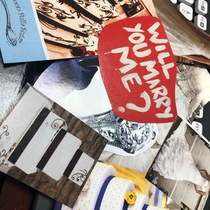 May include: A collage of wedding-themed images including a red heart-shaped cutout with the white text WILL YOU MARRY ME?, photographs of tiered cakes with intricate designs, a diamond ring, and a white wedding dress, all arranged on a dark surface.