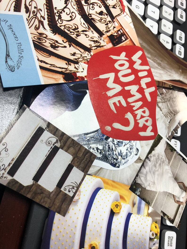 May include: A collage of wedding-themed images including a red heart-shaped cutout with the white text WILL YOU MARRY ME?, photographs of tiered cakes with intricate designs, a diamond ring, and a white wedding dress, all arranged on a dark surface.