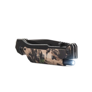 May include: A black and camouflage folding knife with a built-in flashlight. The knife has a personalized inscription that reads "JONATHAN".