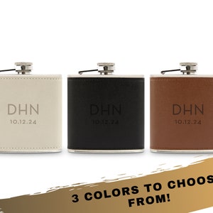 May include: Three leather-covered hip flasks in white, black, and brown with the initials "DHN" and the date "10.12.24" engraved on each.