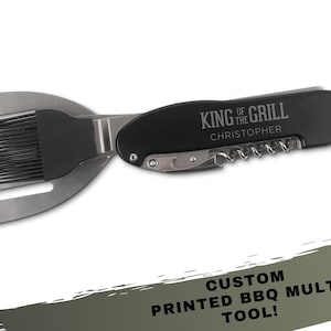 May include: A black and silver BBQ multi-tool featuring the text "KING OF THE GRILL" and the name "Christopher". The tool combines a spatula, basting brush, and corkscrew. The text "CUSTOM PRINTED BBQ MULTI TOOL!" is also visible.