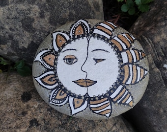 Sun/moon painted on stone