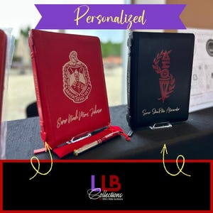 May include: Red and black personalized journals with silver accents. The red journal features a crest and the name "Sorer Nicole Mins Johnson." The black journal displays a design and the name "Sorer Sha Rita Alexander." The word "Personalized" is at the top.