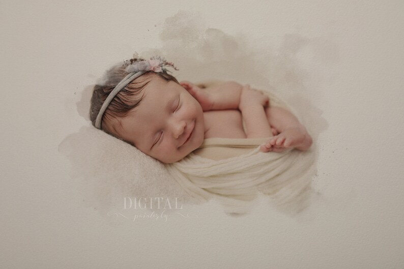 May include: A newborn baby girl sleeping peacefully in a white swaddle, wearing a light blue headband with a floral accent. The baby is smiling softly and has a light complexion.