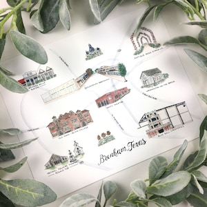 May include: A hand-drawn map of Brenham, Texas, featuring various landmarks and businesses, including the Braeos Belle Burton, Old Main - Blinn College, Henkel Square Market - Round Top, Unity Theatre, Washington on the Brazos, Blue Bell Creameries, and Antique Rose Emporium. The map is drawn in watercolor and ink on white paper.