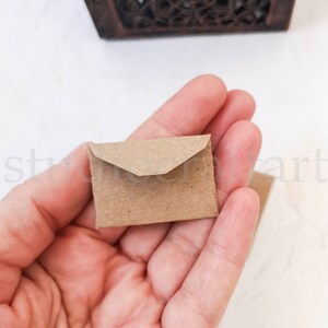 May include: A small brown paper envelope with a pointed flap.