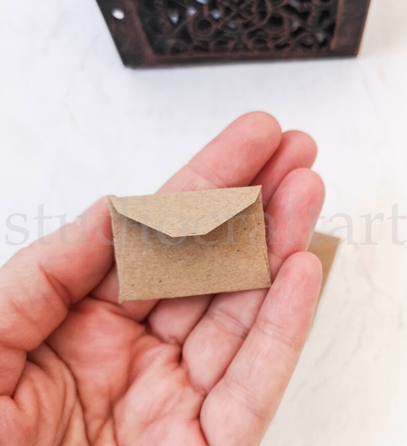 May include: A small brown paper envelope with a pointed flap.