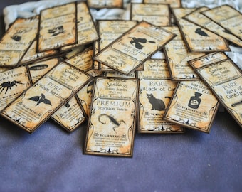 May include: A pile of aged-looking potion labels, each with a unique design and text. The labels feature illustrations of spiders, cats, and other eerie symbols. Text includes "Rare Spider Legs" and "Premium Scorpion Venom".