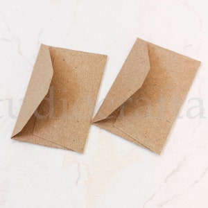 May include: Two brown paper envelopes, folded and ready for use. The envelopes are made of a textured paper and have a natural, rustic look.