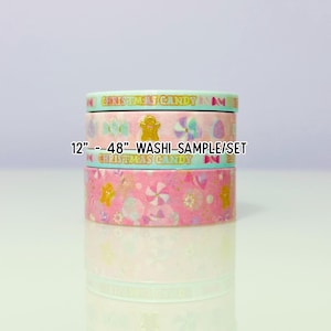 May include: Three rolls of washi tape stacked on top of each other. The top roll is light green with the words "Christmas Candy". The middle roll is pink with a gingerbread man and the text "12"--48" Washi-Sample/Set". The bottom roll is pink with candy designs.