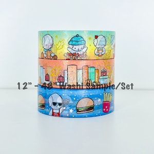 May include: Three rolls of 12-inch washi tape featuring cute cartoon dogs with autumn and food themes. The top roll has a gold background with a dog wearing a blue hat and holding a pumpkin. The middle roll has an orange background with a dog holding a book. The bottom roll has a blue background with a dog holding a spatula and a burger.