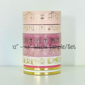 May include: A set of six 12-inch washi tapes with pink and gold designs. The tapes feature a variety of patterns, including stars, hearts, and bees. The text "12" - "48" Washi Sample/Set" is printed on the tapes.