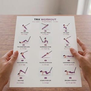 May include: A white printed workout guide titled "TRX WORKOUT" with exercise illustrations. The guide includes exercises like TRX Low Row, Chest Press, and Squat. The guide is held by two hands.