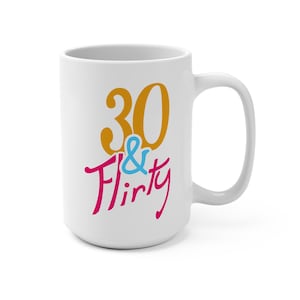 May include: White ceramic mug with a gold 30 and the words "& Flirty" in pink and blue.