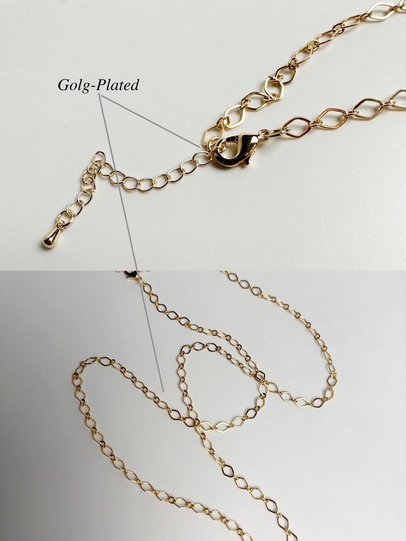 May include: Gold-plated chain necklace with a lobster clasp closure. The chain is made of small, oval-shaped links.