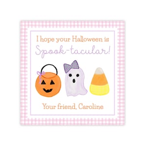 May include: A square card with a pink gingham border featuring the text I hope your Halloween is Spook-tacular! and Your friend, Caroline. Illustrations include an orange pumpkin bucket, a white ghost with a purple bow, and candy corn.