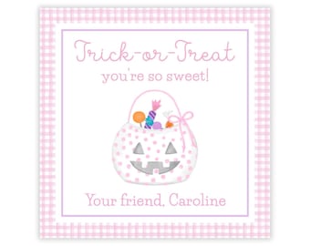 May include: A square gift tag with a light pink gingham border. The center features a white background with the pink text Trick-or-Treat you're so sweet, a polka-dot jack-o'-lantern bucket filled with colorful candy, and Your friend, Caroline.