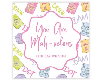 May include: A pink and white card with a whimsical design featuring colorful illustrations of dice and the text "You Are Mah-velous" with the name "LINDSAY WILSON" below.