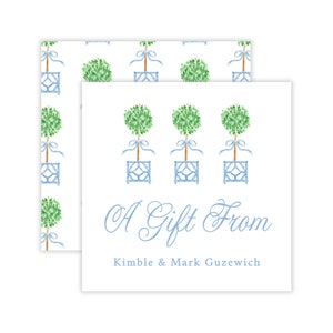 May include: A white gift tag with a blue and white pattern of topiary trees. The text "A Gift From Kimble & Mark Guzewcih" is printed in blue cursive.