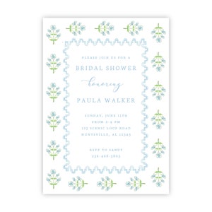 May include: A blue and white floral border surrounds a white invitation card with text that reads "Please join us for a Bridal Shower honoring Paula Walker. Sunday, June 11th from 2-4 PM. 123 Scenic Loop Road, Huntsville, AL 12345. RSVP to Sandy 256-468-5805."
