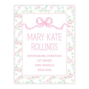 May include: A rectangular card with a floral pattern of pink roses and blue flowers on a white background. The card features a pink bow and the text "MARY KATE ROLLINGS" and other details about the school year.