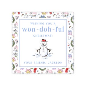 May include: Square Christmas card with a blue border and a snowman illustration wearing a red hat. The card reads "Wishing you a won-doh-ful Christmas!" and "Your friend, Jackson."